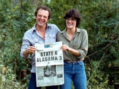 Ralph Carl Rushing and Patti Tyler Rushing are posing by holding the newspaper.